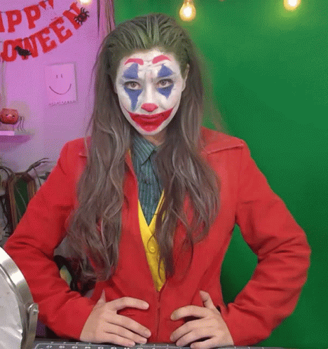 Woman In Joker Costume In Front Of Green Screen GIF