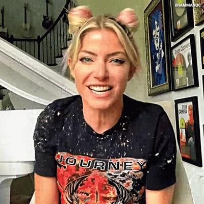 Woman In Journey T-Shirt Smiling At Piano GIF