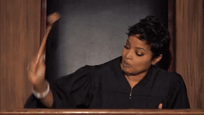 Woman In Judge Robe Holding Wooden Stick GIF