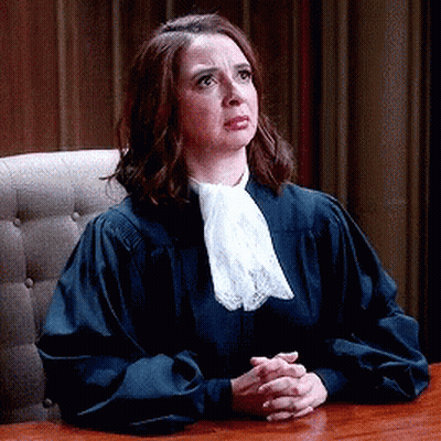 Woman In Judge Robe Sitting At Table GIF