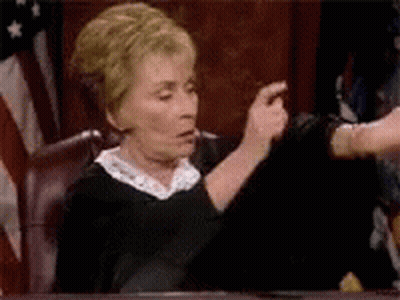 Woman In Judge's Chair Pointing GIF