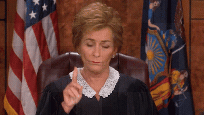 Woman In Judge's Chair With Flag GIF