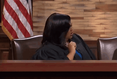 Woman In Judge's Robe Sitting At Table GIF