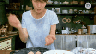 Woman In Kitchen With Plate And Sign Saying 52 GIF