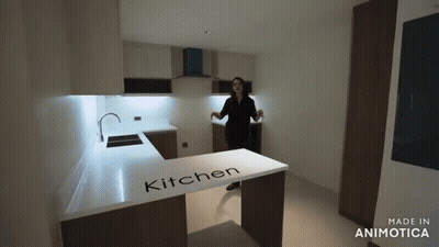 Woman In Kitchen With Word On Counter GIF