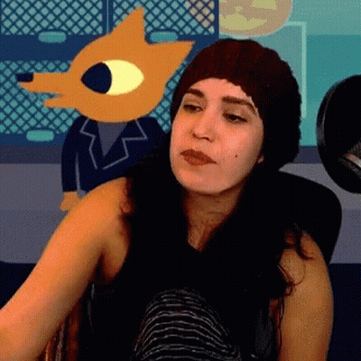 Woman In Knitted Hat Sitting In Front Of Cartoon Character GIF