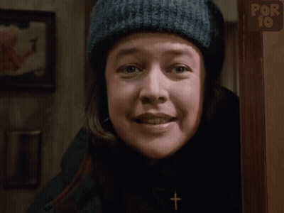 Woman In Knitted Hat Smiling In Front Of Por 10 Sign GIF