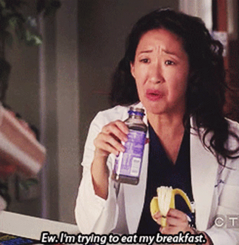 Woman In Lab Coat Eating Banana And Drinking Water GIF