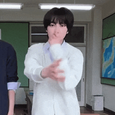 Woman In Lab Coat Holding White Object GIF