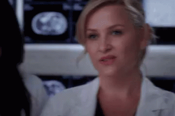 Woman In Lab Coat Looking At MRI Scan GIF