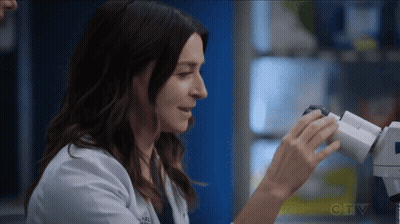 Woman In Lab Coat Looking Through Microscope GIF