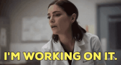 Woman In Lab Coat Saying I'm Working On It GIF