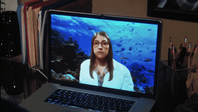 Woman In Lab Coat With Glasses On Laptop Screen GIF