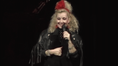 Woman In Leather Jacket Holding Microphone GIF