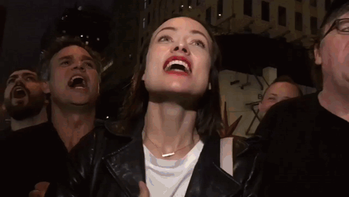 Woman In Leather Jacket Smiling Looking Up GIF