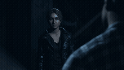 Woman In Leather Jacket Standing In Dark GIF