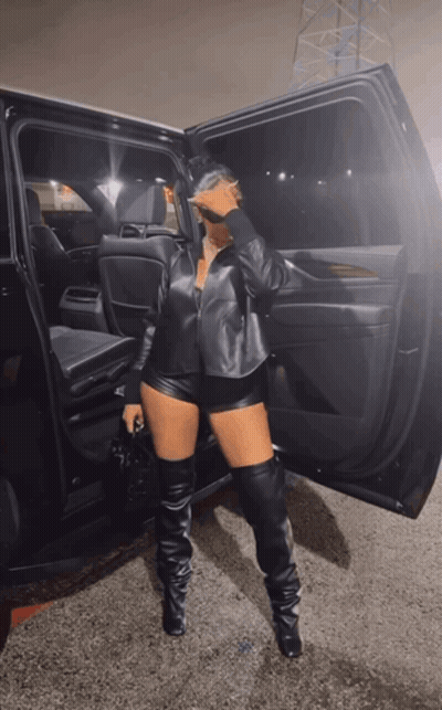 Woman In Leather Shorts And Thigh High Boots By Car GIF
