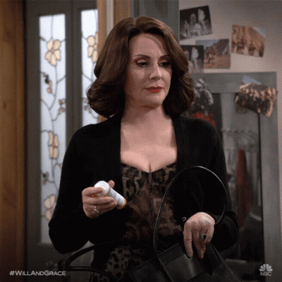 Woman In Leopard Dress Holding Pills And Purse GIF