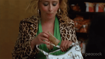 Woman In Leopard Jacket Holding Purse And Sandwich GIF