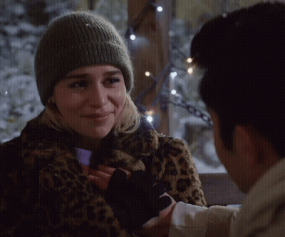 Woman In Leopard Print Coat And Beanie Holding Man's Hand GIF