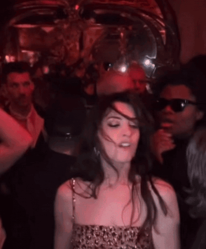 Woman In Leopard Print Dress Dancing In Crowd GIF