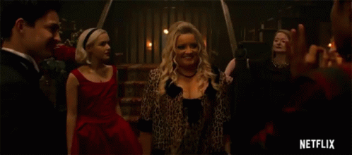 Woman In Leopard Print Dress Dancing With Two Men In Tuxedos GIF