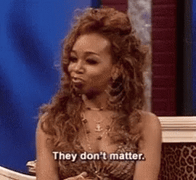 Woman In Leopard Print Dress Sitting On Couch Saying They Don't Matter GIF