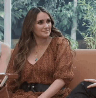 Woman In Leopard Print Dress Sitting On Couch With Man GIF