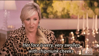 Woman In Leopard Print Jacket With Swollen Chipmunk Cheeks GIF