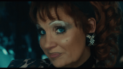 Woman In Leopard Print Shirt And Earrings GIF