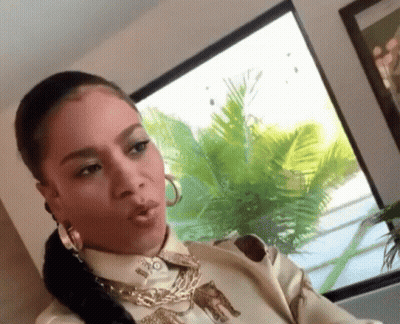Woman In Leopard Print Shirt And Hoop Earrings GIF