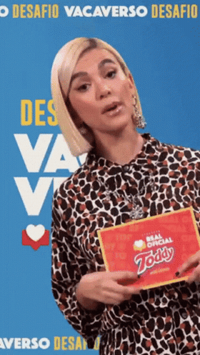 Woman In Leopard Print Shirt Holding Zoddy Card GIF