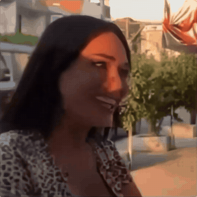 Woman In Leopard Print Shirt Smiling In Front Of Trees GIF