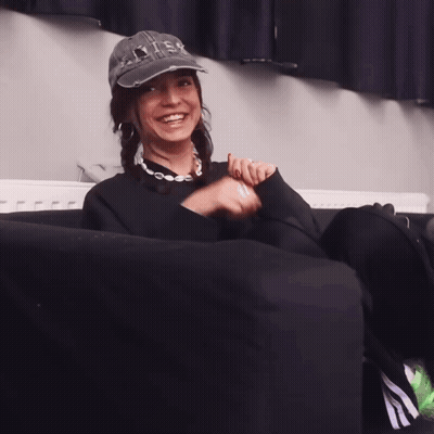 Woman In Levis Hat Sitting On Couch GIF