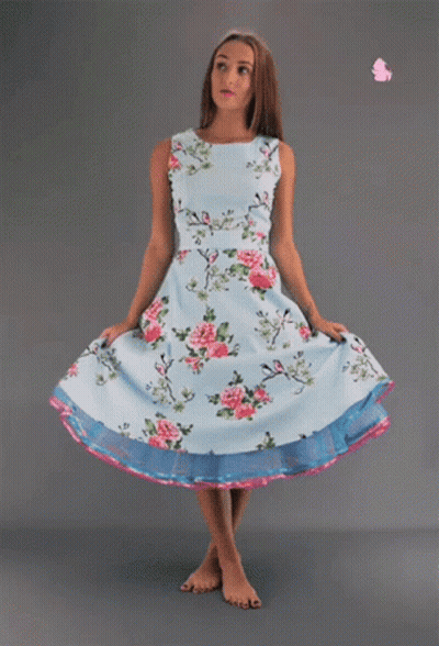 Woman In Light Blue Floral Dress And Pink Rose GIF