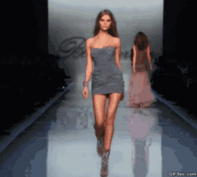 Woman In Light Blue Hoodie Looking Over Shoulder GIF
