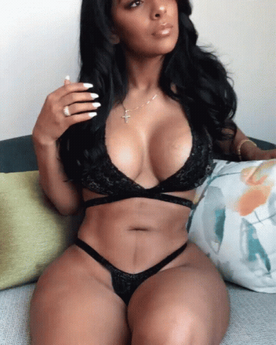 Woman In Lingerie Sitting On Couch With Cross Necklace GIF