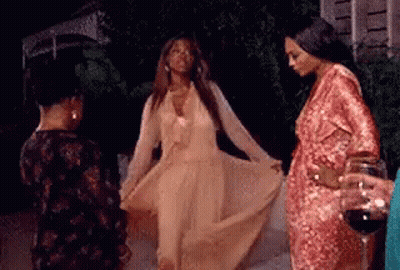 Woman In Long Dress Dancing With Two Women And Wine Holder GIF