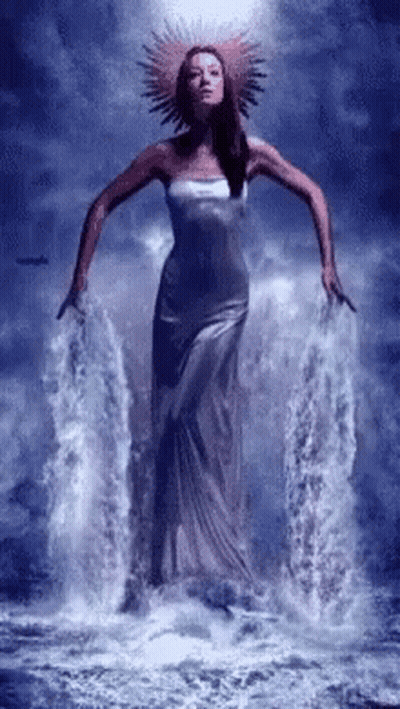 Woman In Long Dress Standing In Water GIF