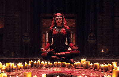 Woman In Lotus Position In Front Of Candles GIF