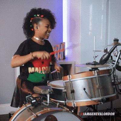 Woman In Malcolm Shirt Playing Drums GIF