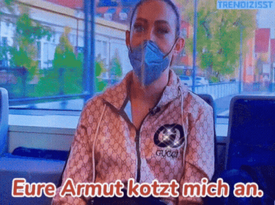Woman In Mask And Gucci Jacket Says Eure Armut Kotzt Mich An GIF