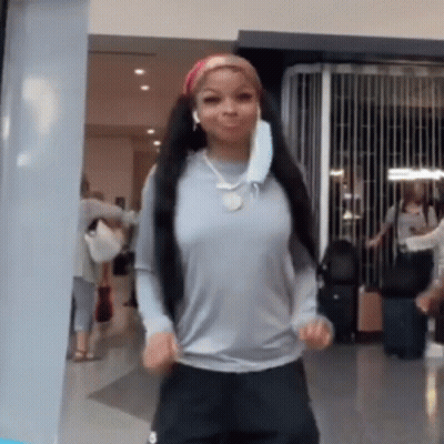 Woman In Mask And Headphones Dancing In Hallway GIF