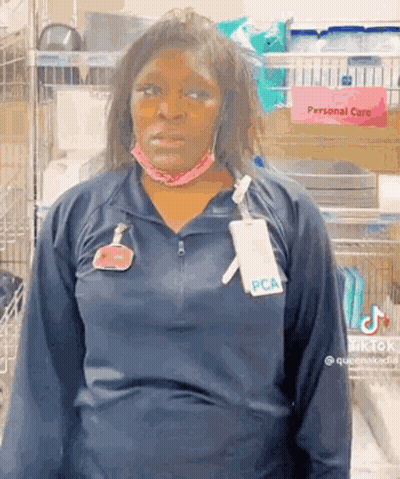 Woman In Mask And PCA Name Tag GIF