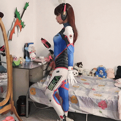 Woman In Meka Costume Standing In Front Of Bed GIF