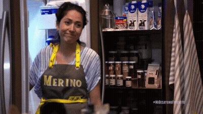Woman In Merino Apron Standing In Front Of Refrigerator GIF