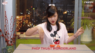 Woman In Mickey Mouse Shirt Cutting Orange GIF