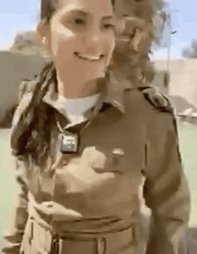 Woman In Military Uniform Smiling In Field GIF