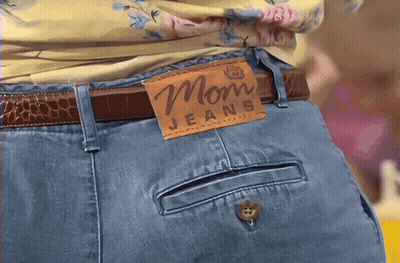 Woman In Mom Jeans With Brown Leather Tag GIF