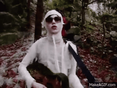 Woman In Mummy Costume Holding Guitar In Woods GIF
